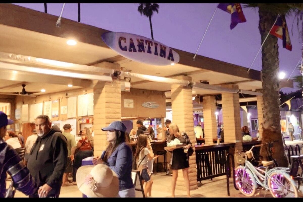 Front of The Campland Cantina restaurant with people walking by.