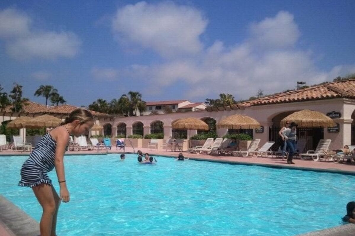 Girl about to jump in pool at a resort