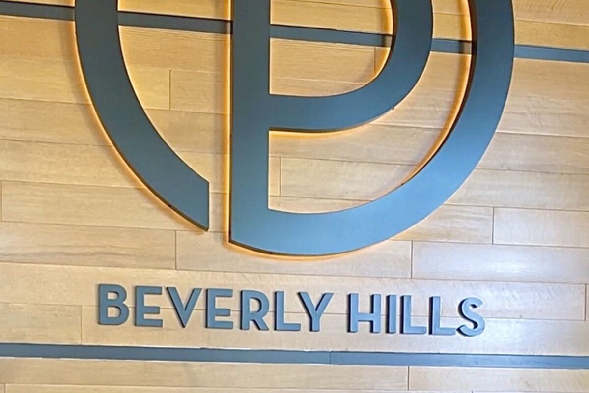 Receptionists below the logo sign at Ocean Prime Beverly Hills restaurant.