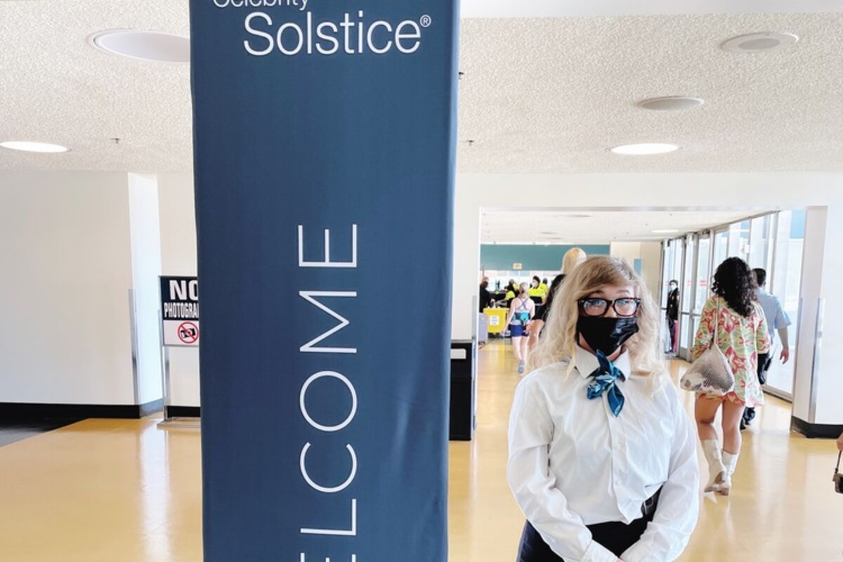 Woman next to a sign Welcome to the Celebrity Solstice Cruise