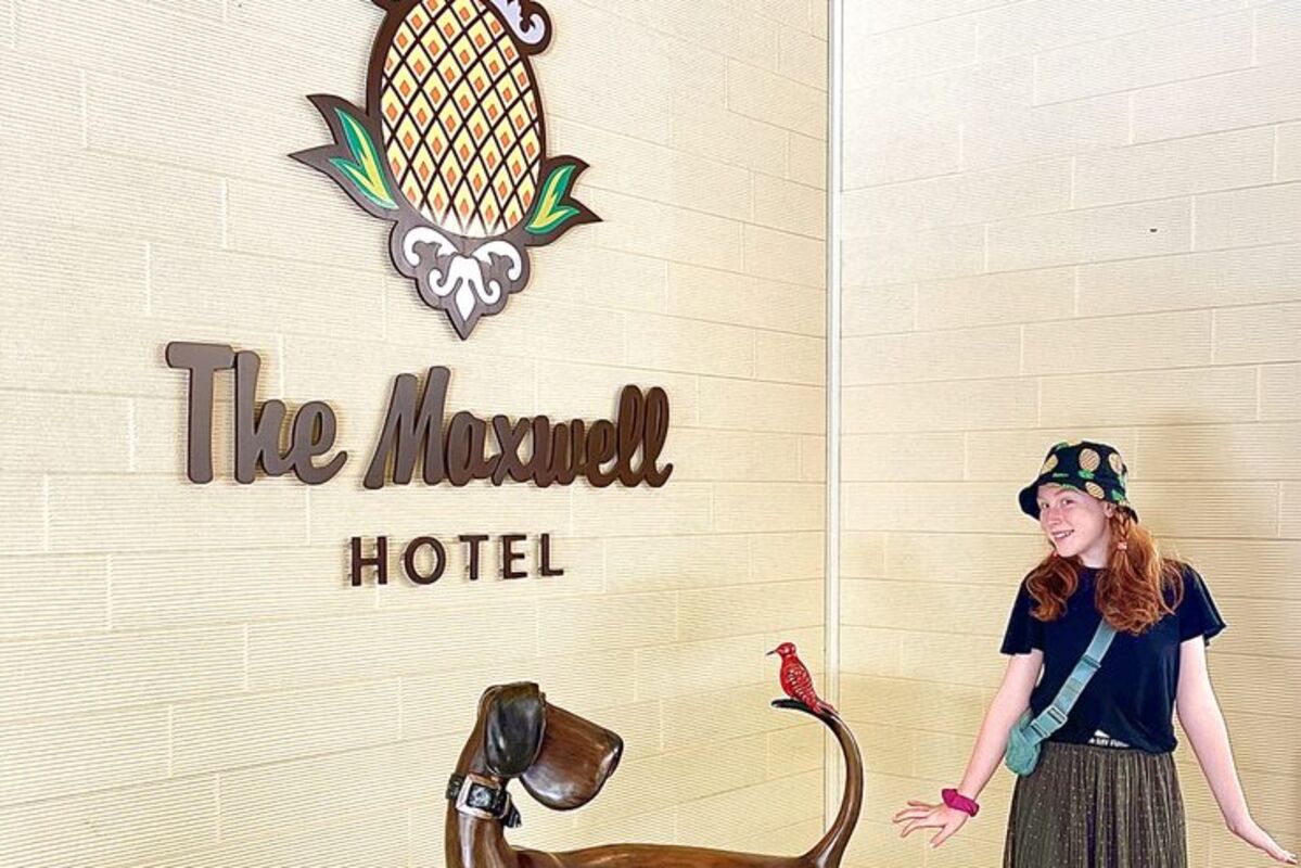 Girl in front of dog-friendly The Maxwell Hotel with a bronze statue of a dog